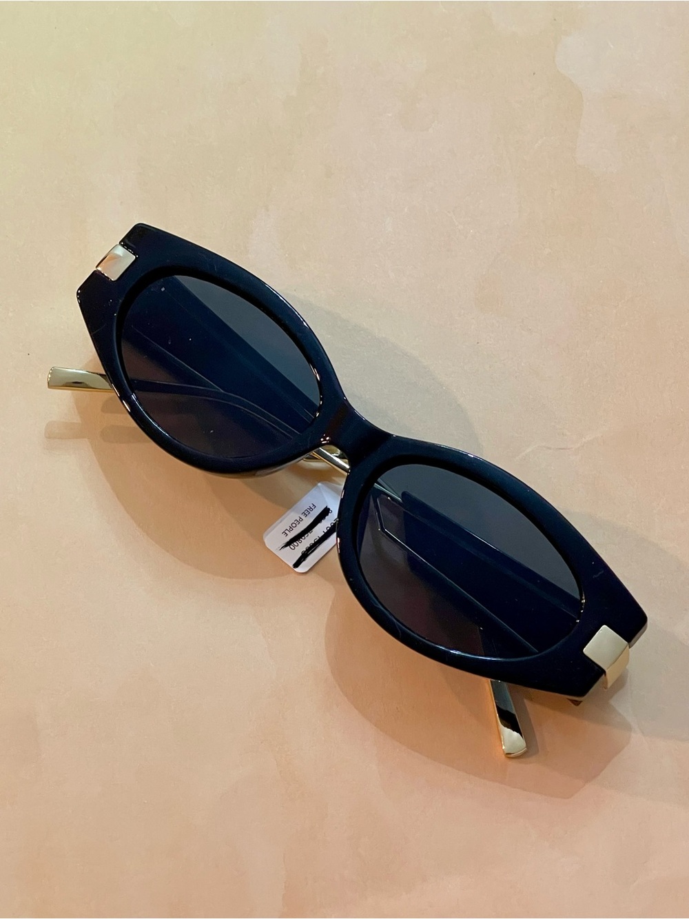 Free People Boho Chic Black Oval Sunglasses with Gold Accents and Black Lenses